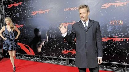 Gabriel Macht waves to photographers as his wife, actress Jacinda Barrett, poses on the red carpet at the premiere of "The Spirit" last week.
Macht plays the title role in "The Spirit."