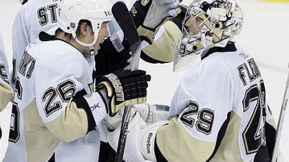 Marc-Andre Fleury is congratulated by teammate Ruslan Fedotenko (26) after shutting out the New Jersey Devils in last night's game at Prudential Center in Newark, N.J.