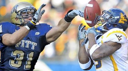 Pitt's Dom DeCicco breaks up a pass intended for West Virginia's Jock Sanders.