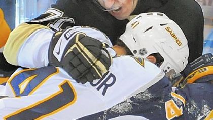 Evgeni Malkin battles with the Sabres' Clarke MacArthur last night at Mellon Arena. Malkin had two assists in the game.