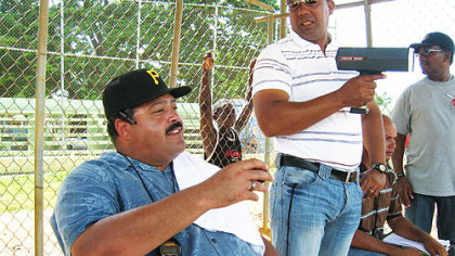Rene Gayo, the Pirates' Latin American scouting director, watches the pitching portion of the tryout, with one of his Dominican scouts, Marino Tejada, holding the radar gun.