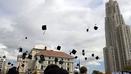 Actors and extras toss their mortarboards into the air while filming "Sorority Row" yesterday near the Cathedral of Learning in Oakland.