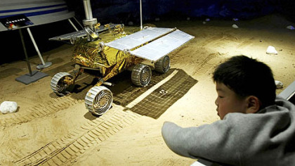 SHANGHAI -- A boy looks at China's explorer vehicle displayed at the Science and Technology Museum. Last September's Shenzhou 7 mission was the first to carry a full crew of three astronauts, one of whom performed China's first spacewalk.