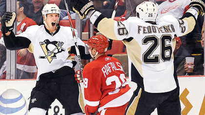 The Penguins' two heroes of the night, Jordan Staal, left, and Ruslan Fedotenko celebrate Fedotenko's winning goal in overtime last night at Joe Louis Arena in Detroit. It capped a wild and improbable comeback for the Penguins.