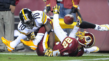 The Redskins' Carlos Rogers breaks up a pass intended for Santonio Holmes last night at FedEx Field in Landover, Md.