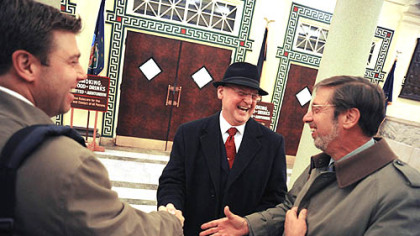 Patrick McMahon, president-business agent of Amalgamated Transit Union Local 85, center, shakes hands with ATU lawyers Joe Pass, right, and Joe Pass Jr. after the ATU voted to accept the Port Authority's proposed contract at the Soldiers & Sailors Memorial Hall last night.