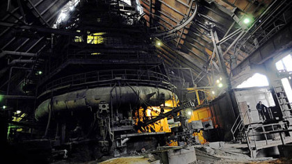 KREMIKOVTZI, Bulgaria -- The man at right is overshadowed by a blast furnace of Bulgaria's biggest steelmaker Kremikovtzi. The plant's majority stake owner, the Indian company Global Steel Holding of Pramod Mittal, the younger brother of ArcelorMittal's steel tycoon Laksmi Mittal, has stopped providing money and raw materials after failing in several attempts to sell it. Management was forced to begin shutting down its blast furnaces and coal batteries last week.