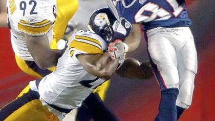 Anthony Smith tries to drag down Patriots receiver Randy Moss in December in Foxborough, Mass.