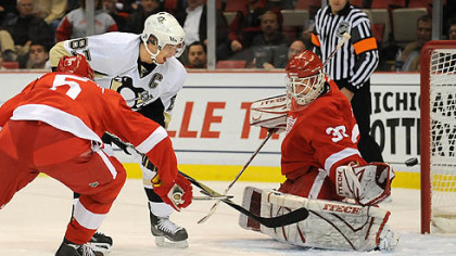 Penguins' Sidney Crosby scores against Redwings goalie Chris Osgood tonight at the Joe Louis Arena, Detroit.