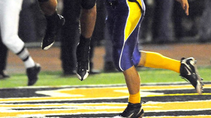 Bethel Park's John Schademan catches a touchdown pass as he's defended by Canon-McMillan's Steve Roach in the first half last night.