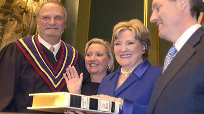 Pennsylvania Lt. Governor Catherine Baker Knoll (second from right) following her swearing-in ceremony in the Pennsylvania Senate Chamber in January of 2003. From left, Pennsylvania Supreme Court Chief Justice Ralph Cappy, Jr. who administered the oath of office, daughter Mina Baker Knoll and Albert Baker Knoll, holding the Bible.